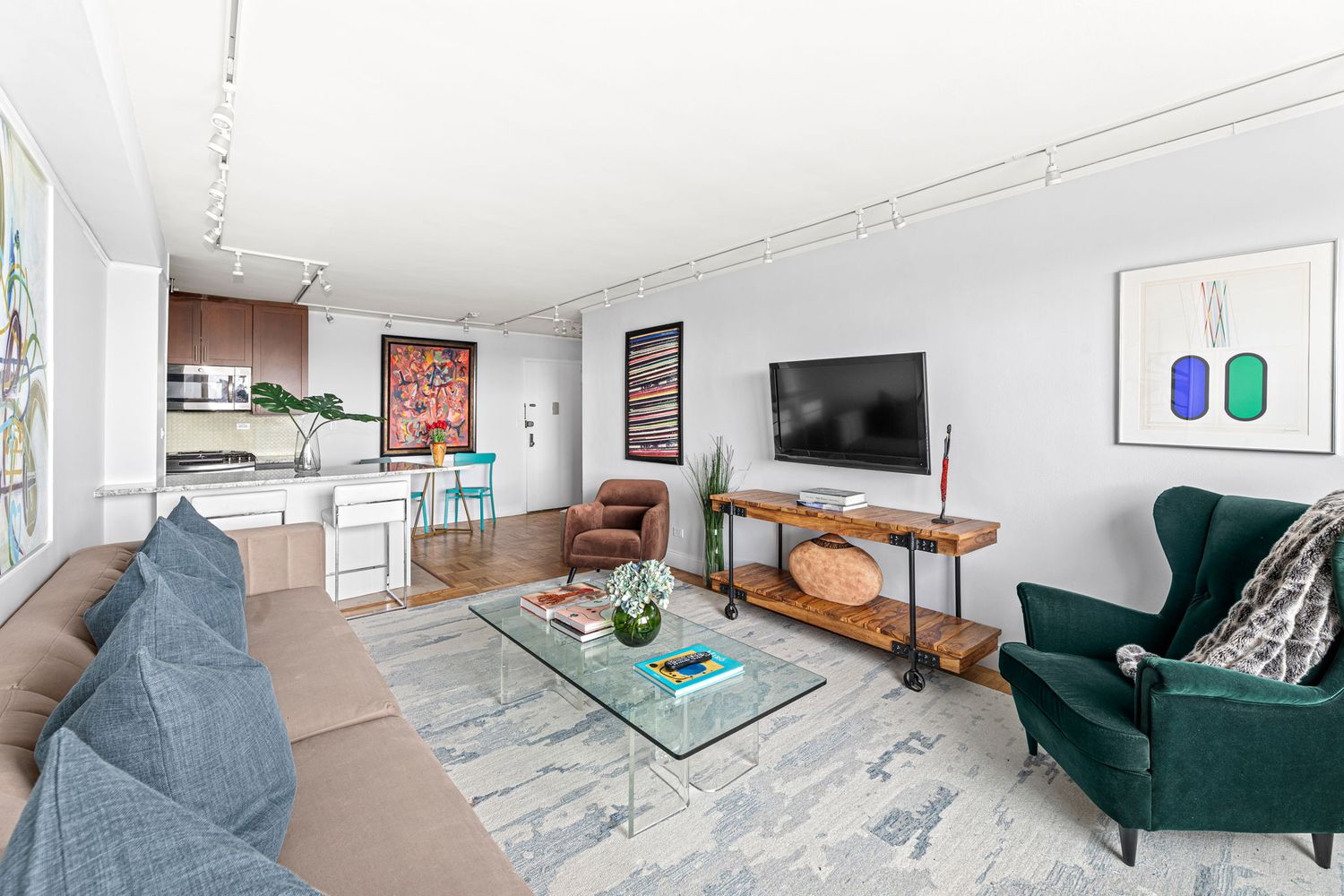 900 West 190th Street, Unit 14E Manhattan, NY 10040 - Photo 3 of 9 a living room with furniture and a flat screen tv