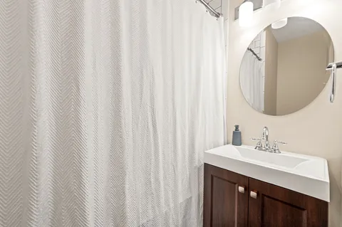 a bathroom with a sink vanity and a mirror