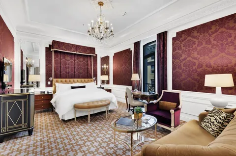 a living room with furniture and a large mirror