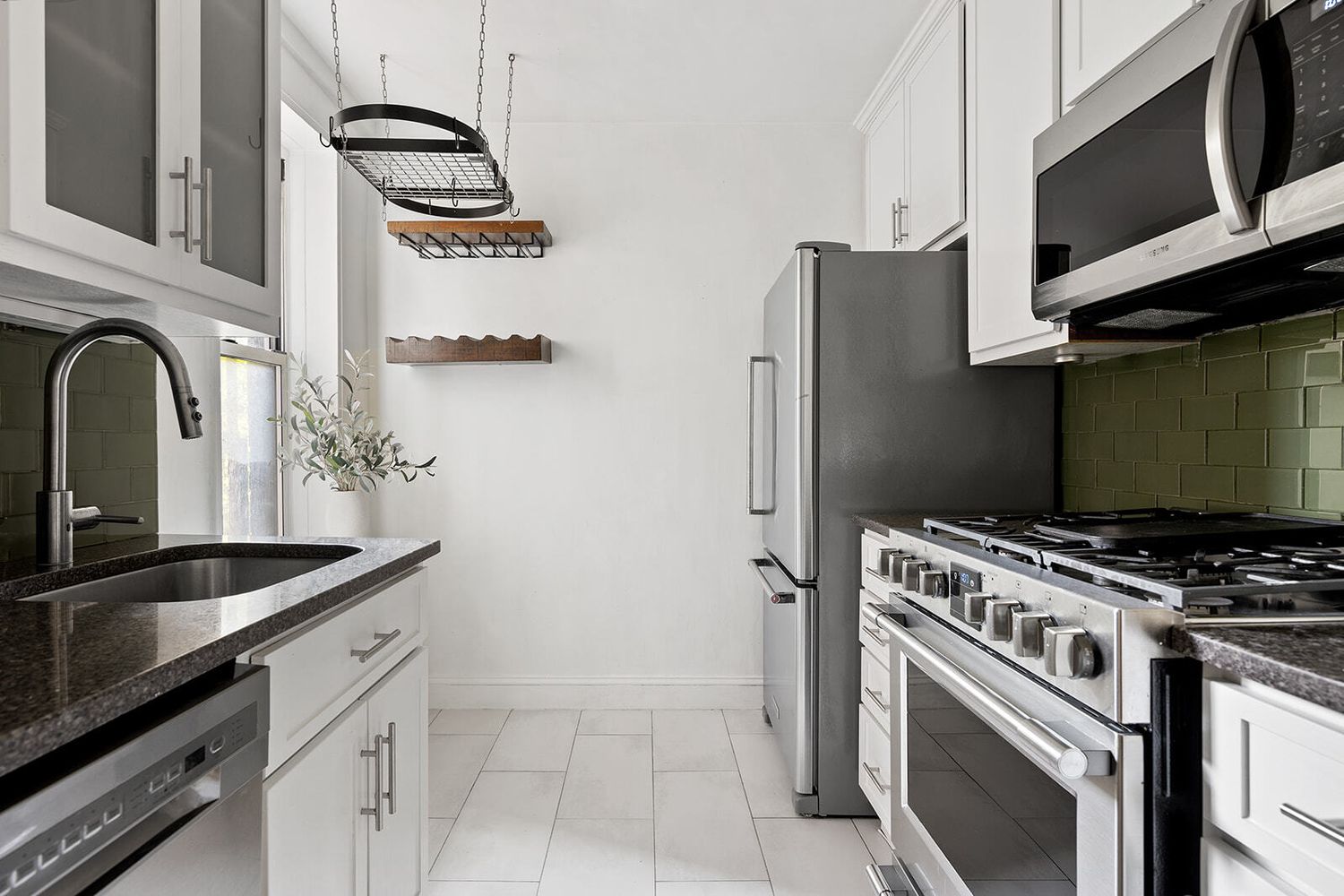 302 East 88th Street, Unit 3F Manhattan, NY 10128 - Photo 1 of 6 a kitchen with stainless steel appliances granite countertop a sink stove and refrigerator