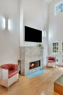a living room with furniture a window and a table