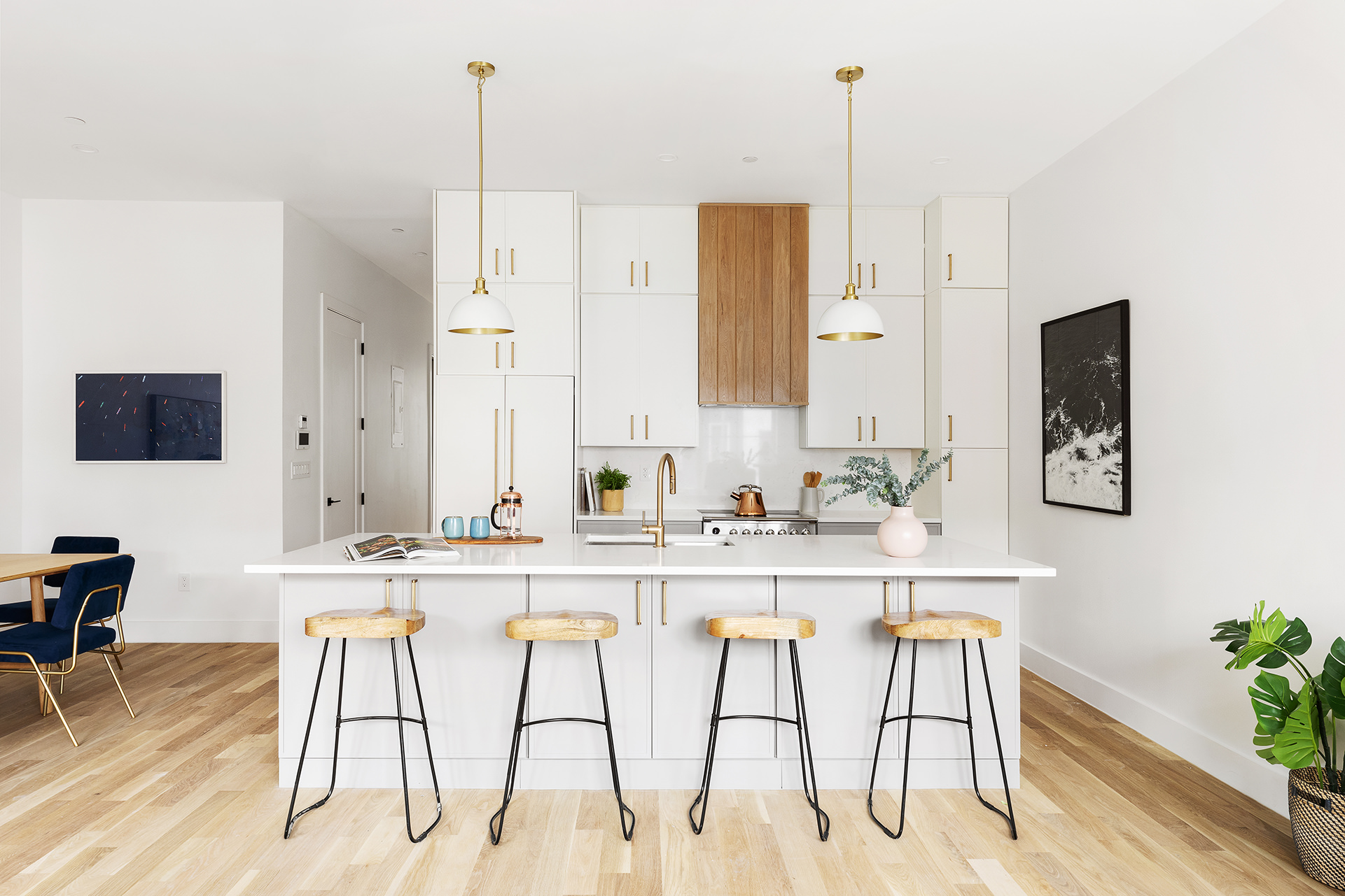 262 17th Street, Unit PH Brooklyn, NY 11215 - Photo 2 of 15 a kitchen with stainless steel appliances kitchen island granite countertop a stove a sink and white cabinets with wooden floor
