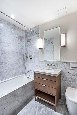 215 Sullivan Street, Unit THC Manhattan, NY 10012 - Photo 13 of 16 a bathroom with a granite countertop sink a toilet and bathtub