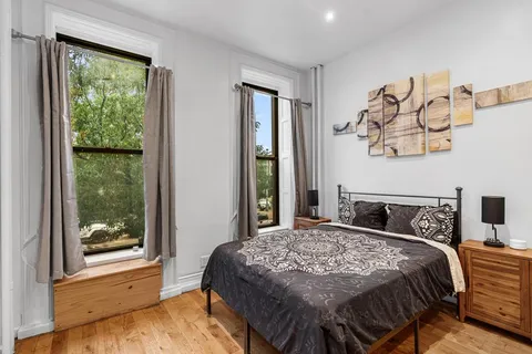 a bedroom with a large bed and a window