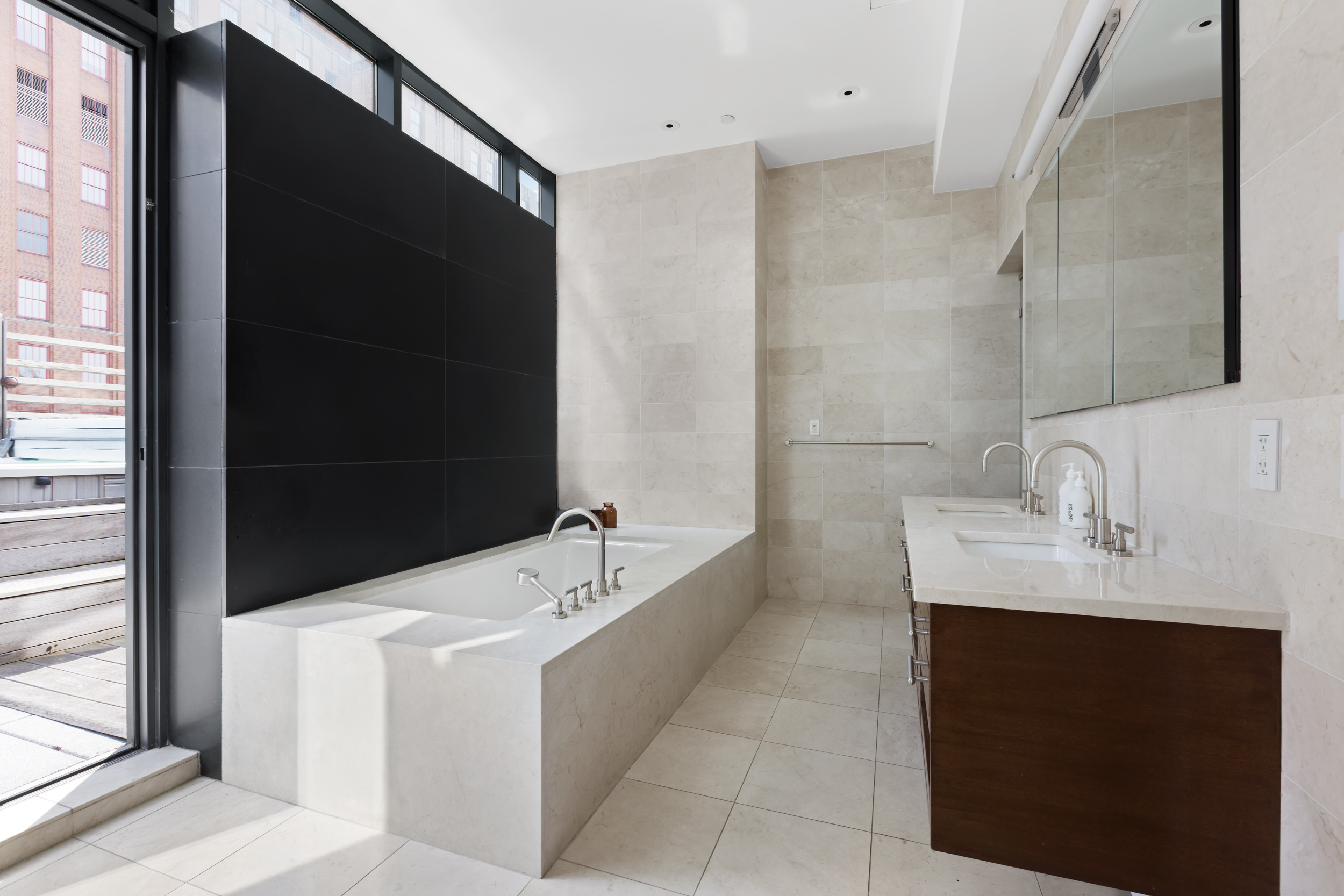 34 Leonard Street, Unit PH Manhattan, NY 10013 - Photo 10 of 30 a bathroom with a tub a sink and mirror