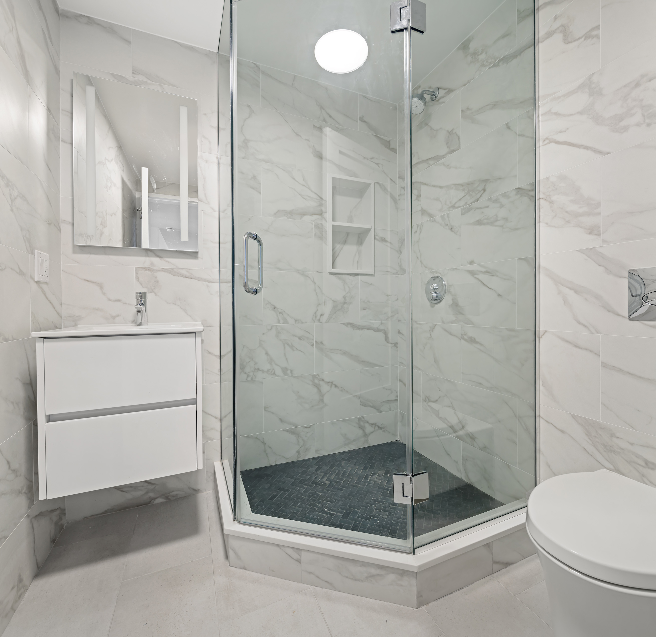 175 West 95th Street, Unit 10C Manhattan, NY 10025 - Photo 13 of 17 a bathroom with a shower a toilet and sink