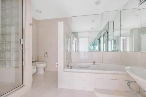 a bathroom with a granite countertop sink mirror and toilet
