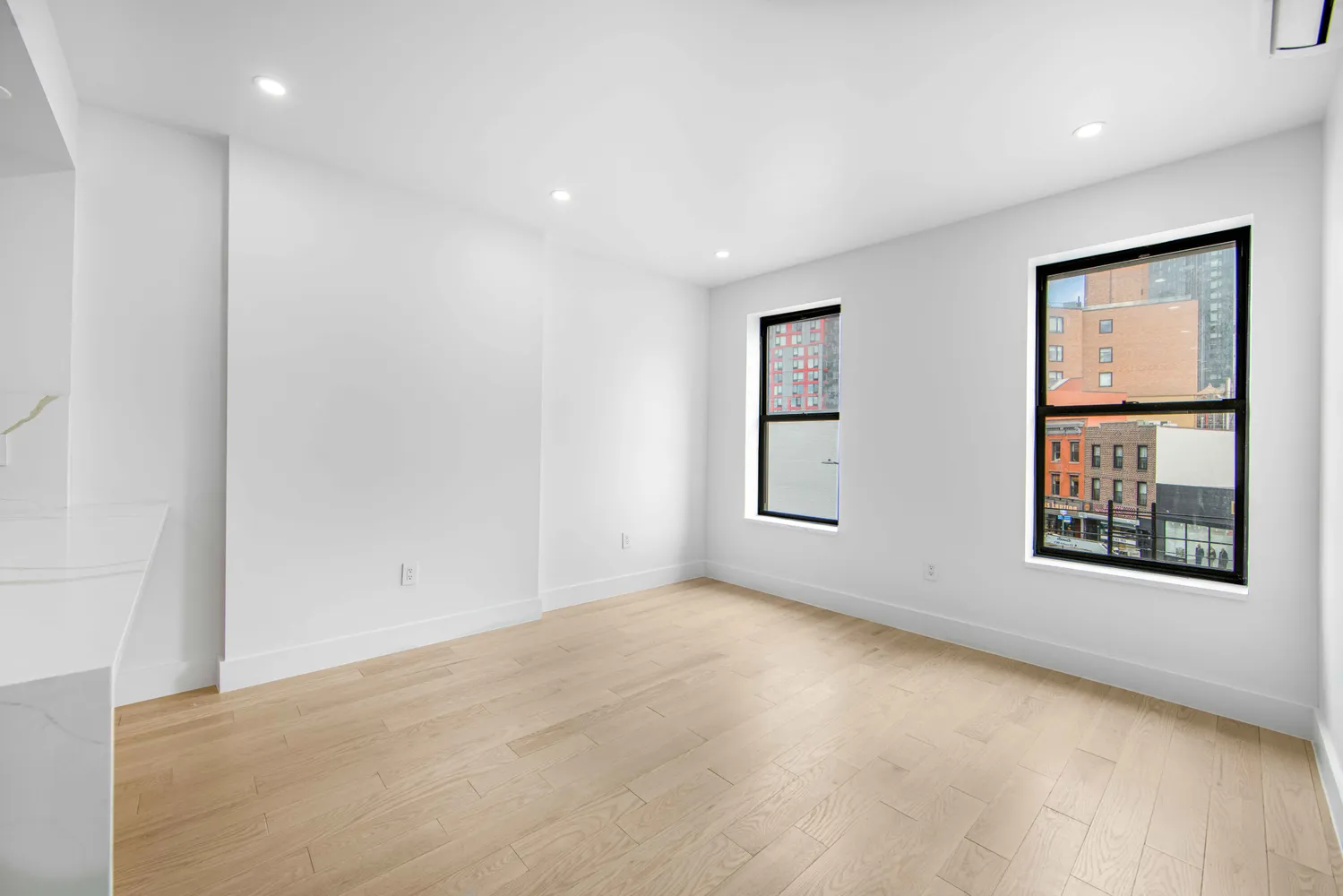 an empty room with windows and closet