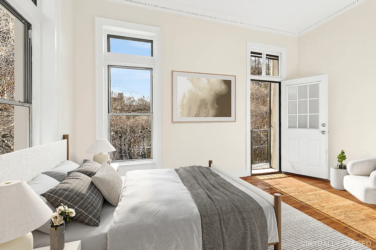 1102 Dean Street, Unit 4 Brooklyn, NY 11216 - Photo 6 of 12 a bedroom with a bed and a painting on the wall