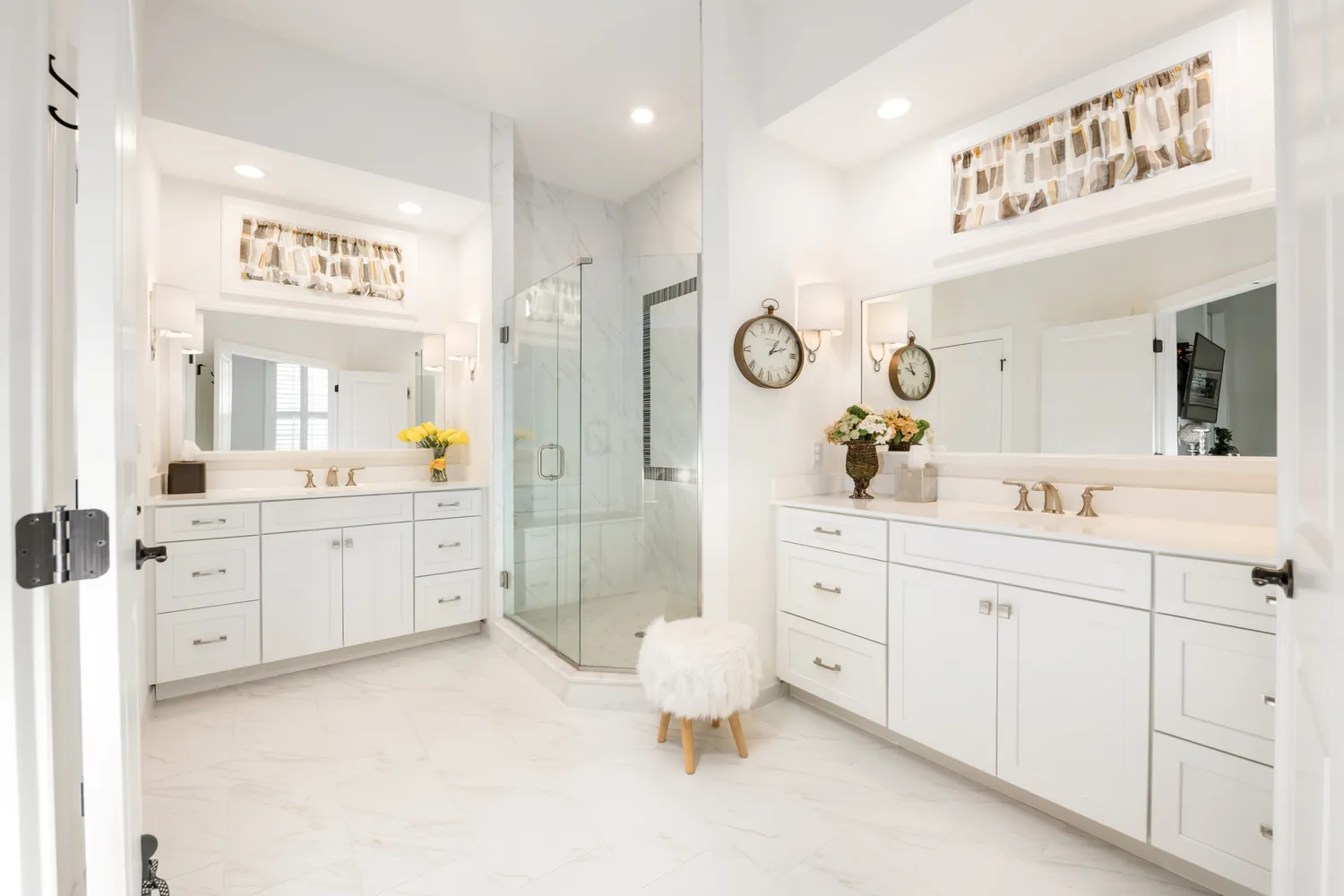 a spacious bathroom with double vanity sink a mirror a vanity and a shower