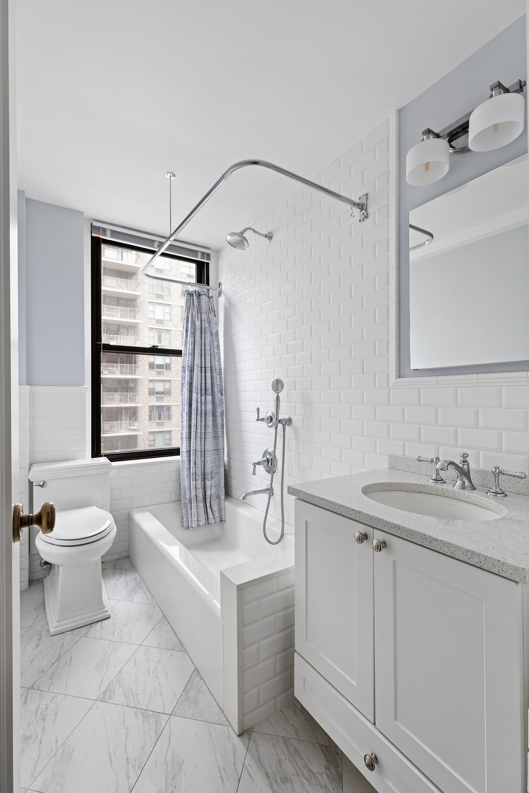 308 East 79th Street, Unit 9E Manhattan, NY 10075 - Photo 6 of 7 a bathroom with a sink toilet and shower
