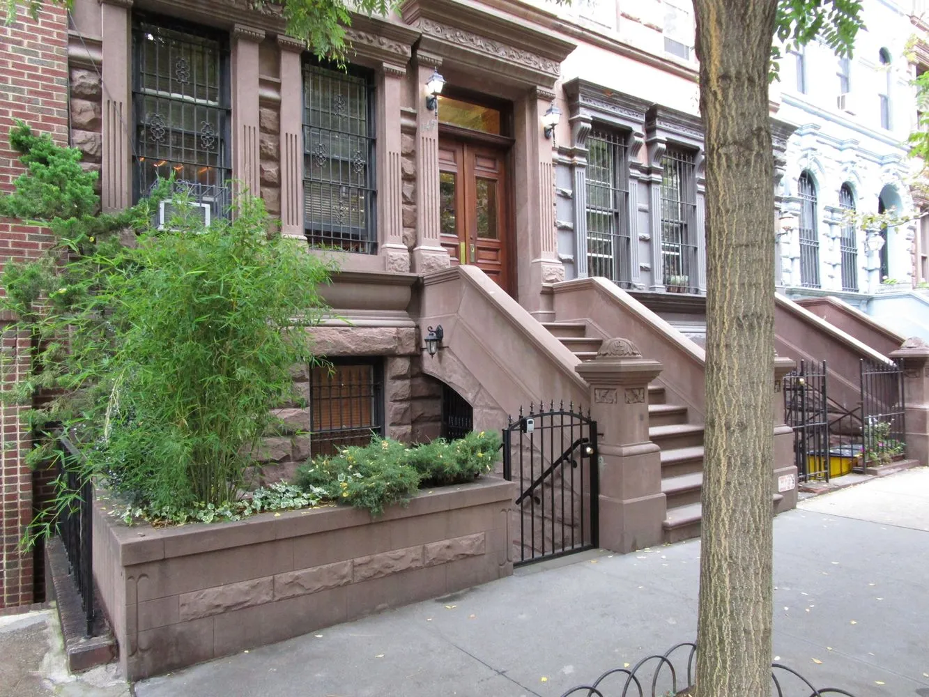 a front view of a building with a garden