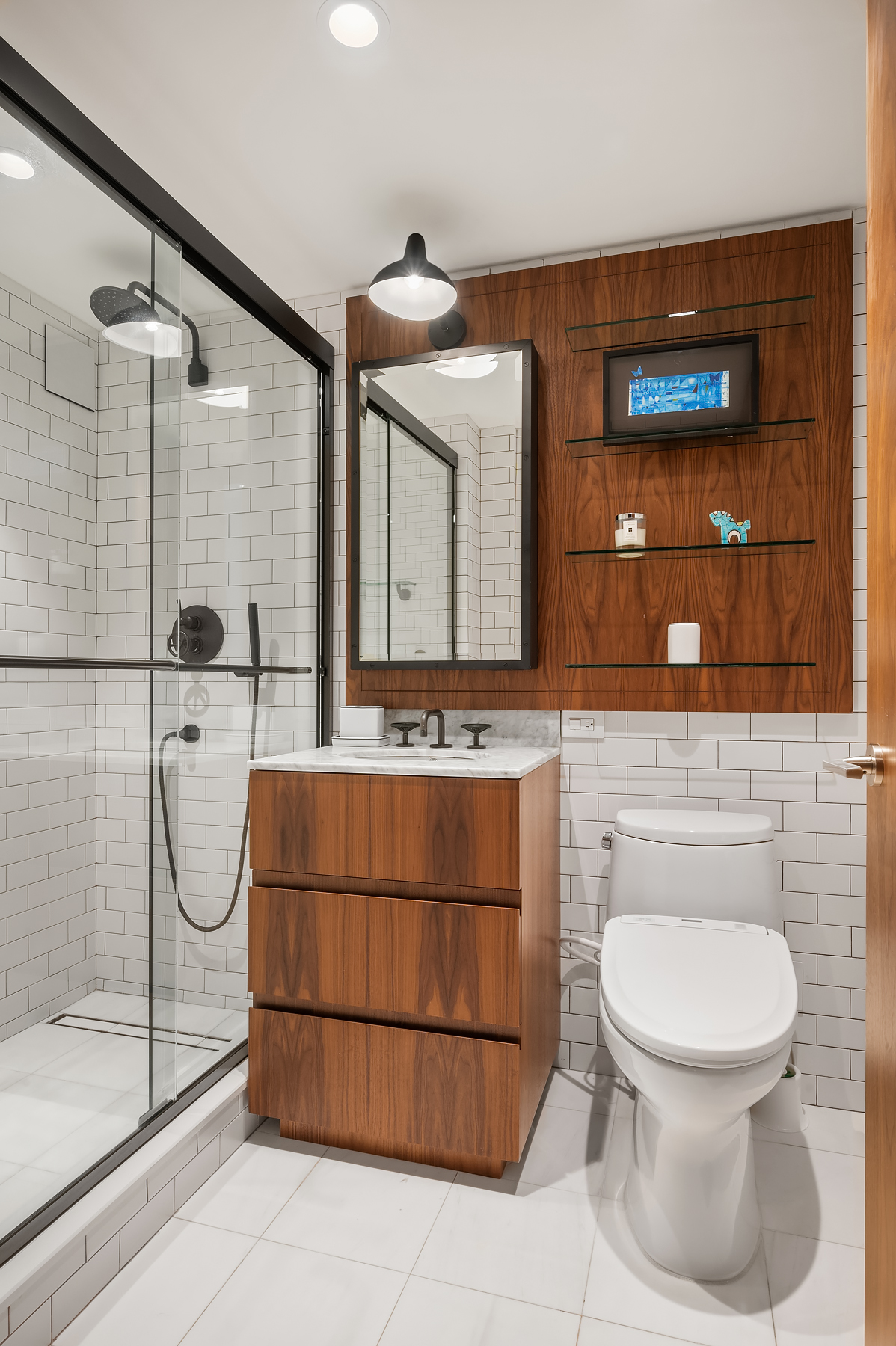 235 East 55th Street, Unit 44B Manhattan, NY 10022 - Photo 7 of 12 a bathroom with a toilet a sink and mirror