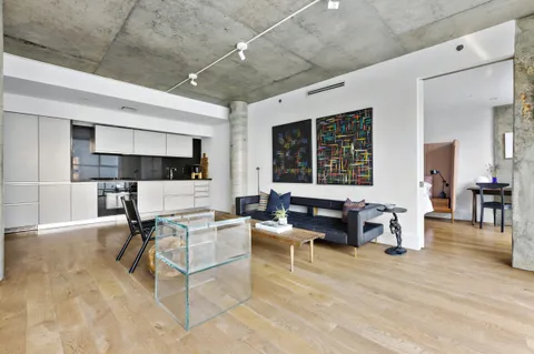 a living room with furniture and view of kitchen