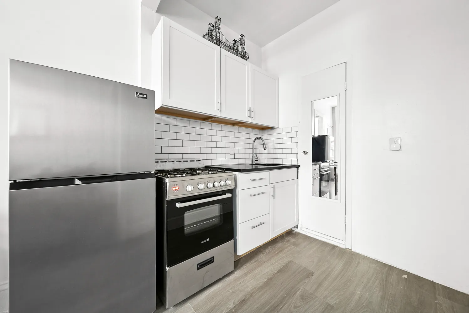 a kitchen with white cabinets and white appliances