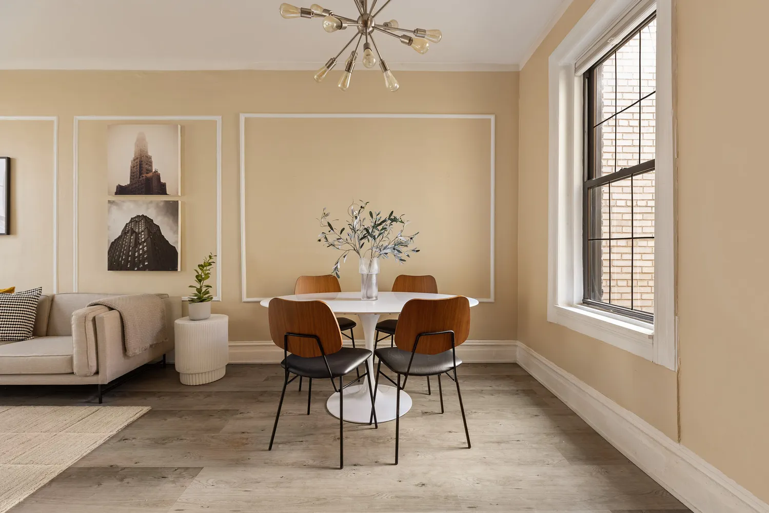 a dining room with furniture a rug and a chandelier