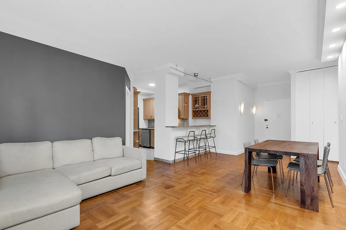 200 East 58th Street, Unit 15B Manhattan, NY 10022 - Photo 3 of 10 a living room with furniture and kitchen view