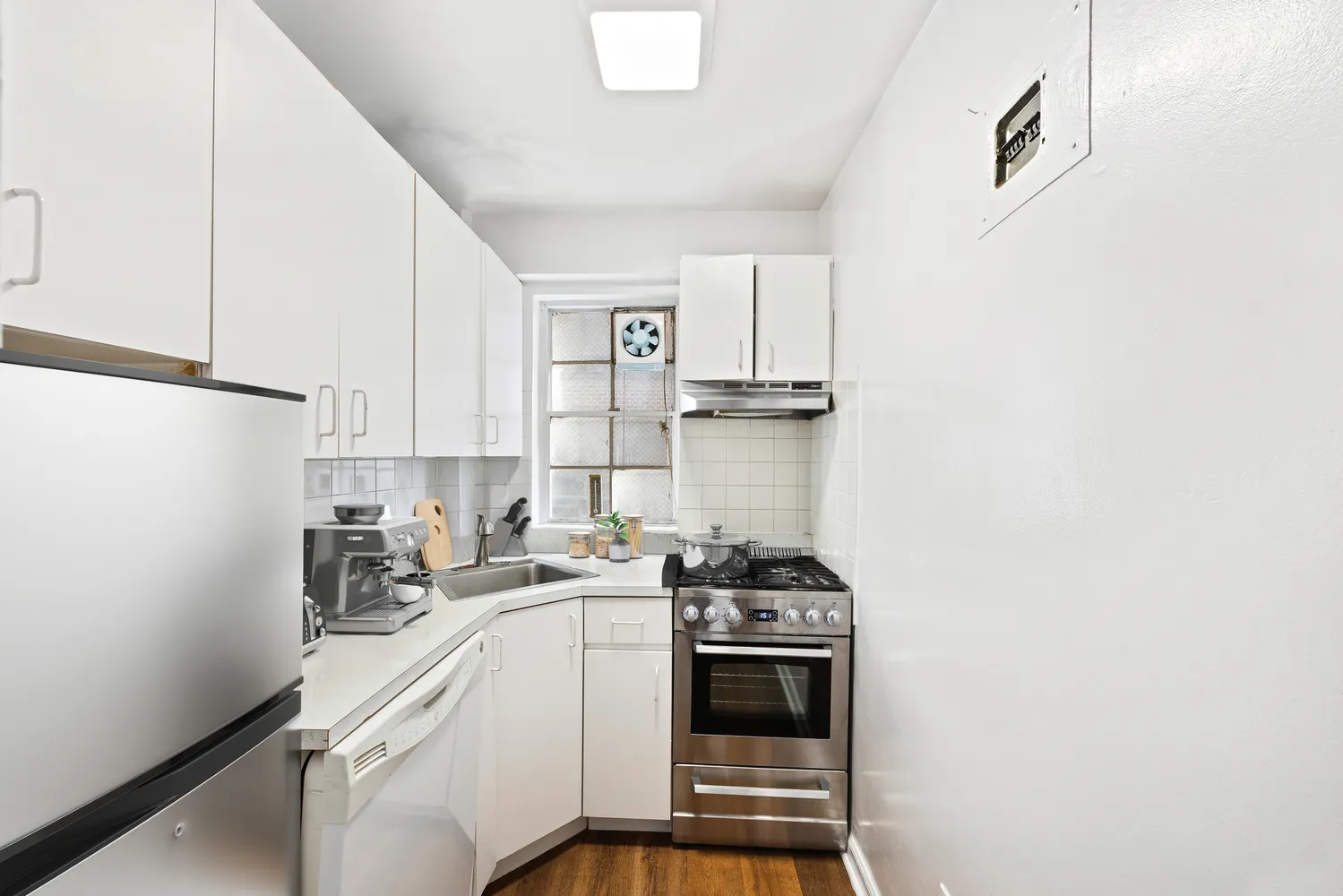 a kitchen with a sink a stove and cabinets