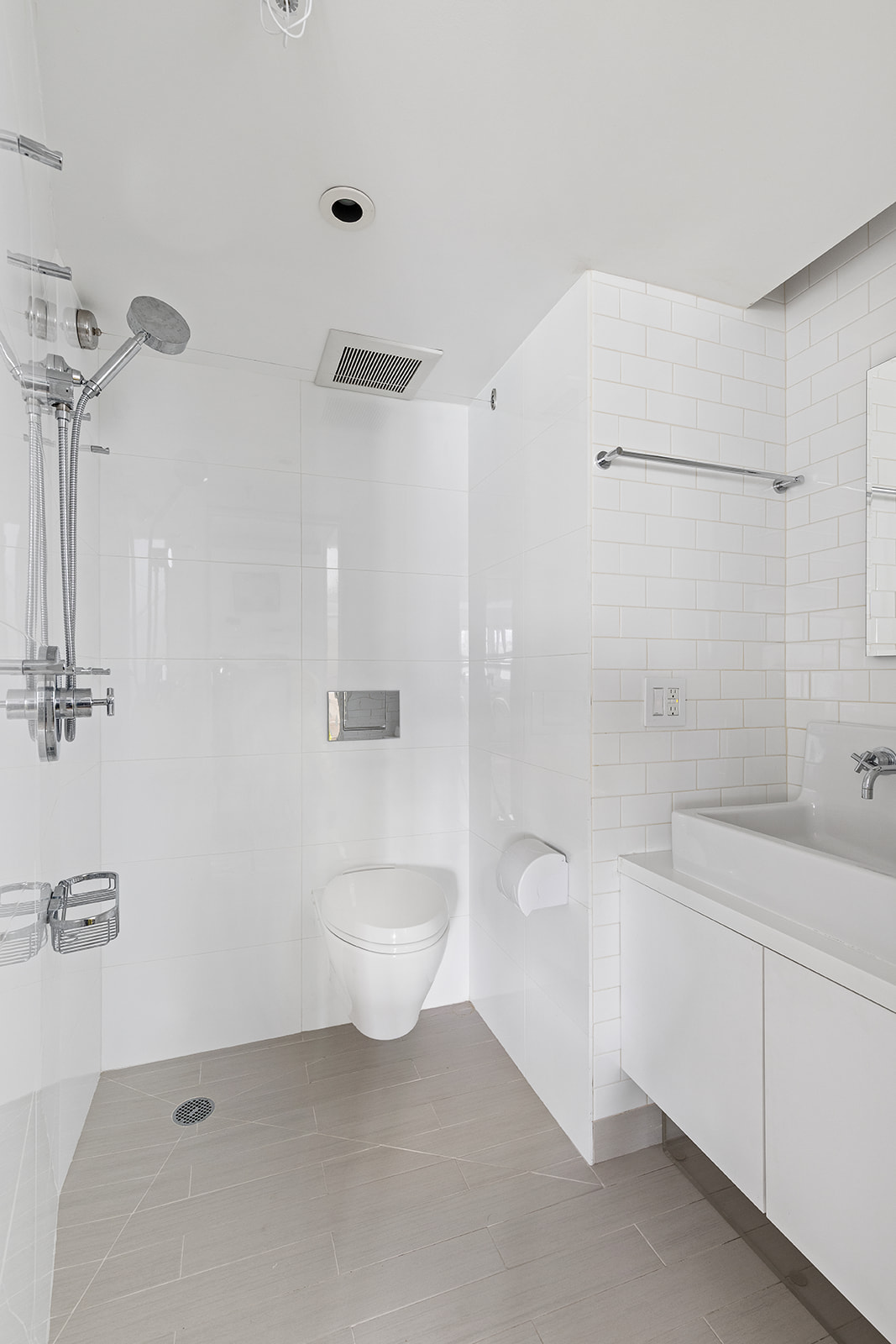 357 West 12th Street, Unit 5E Manhattan, NY 10014 - Photo 8 of 13 a bathroom with a toilet a sink a mirror and shower