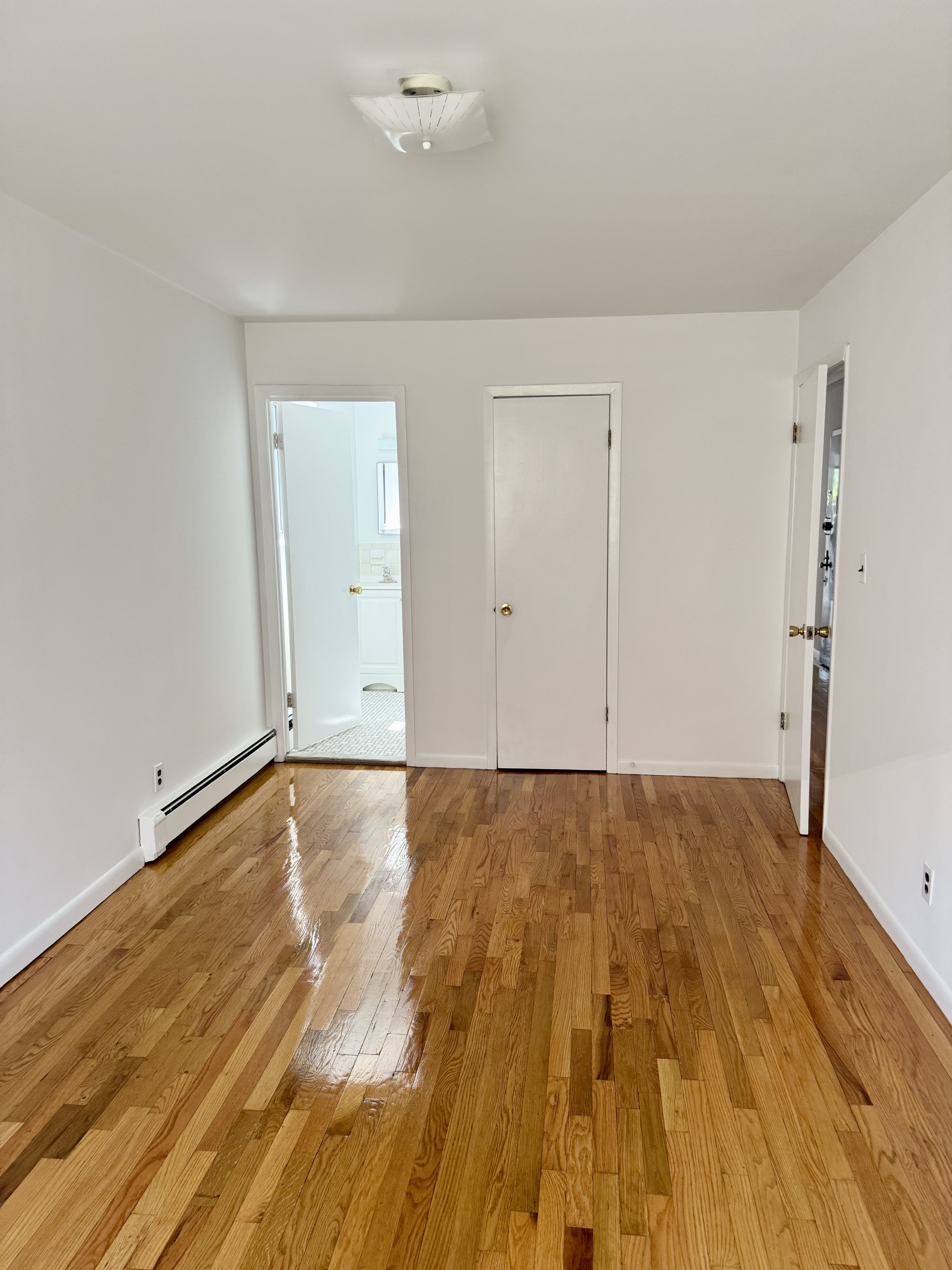 59-15 39th Avenue, Unit 2 Queens, NY 11377 - Photo 8 of 13 wooden floor in a room