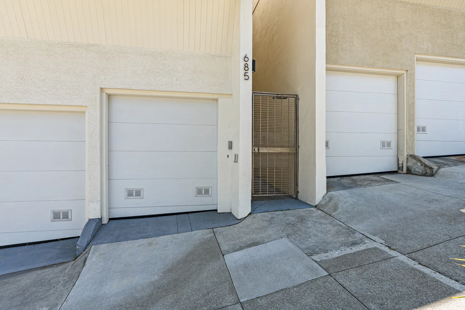 a front view of a building with palm trees
