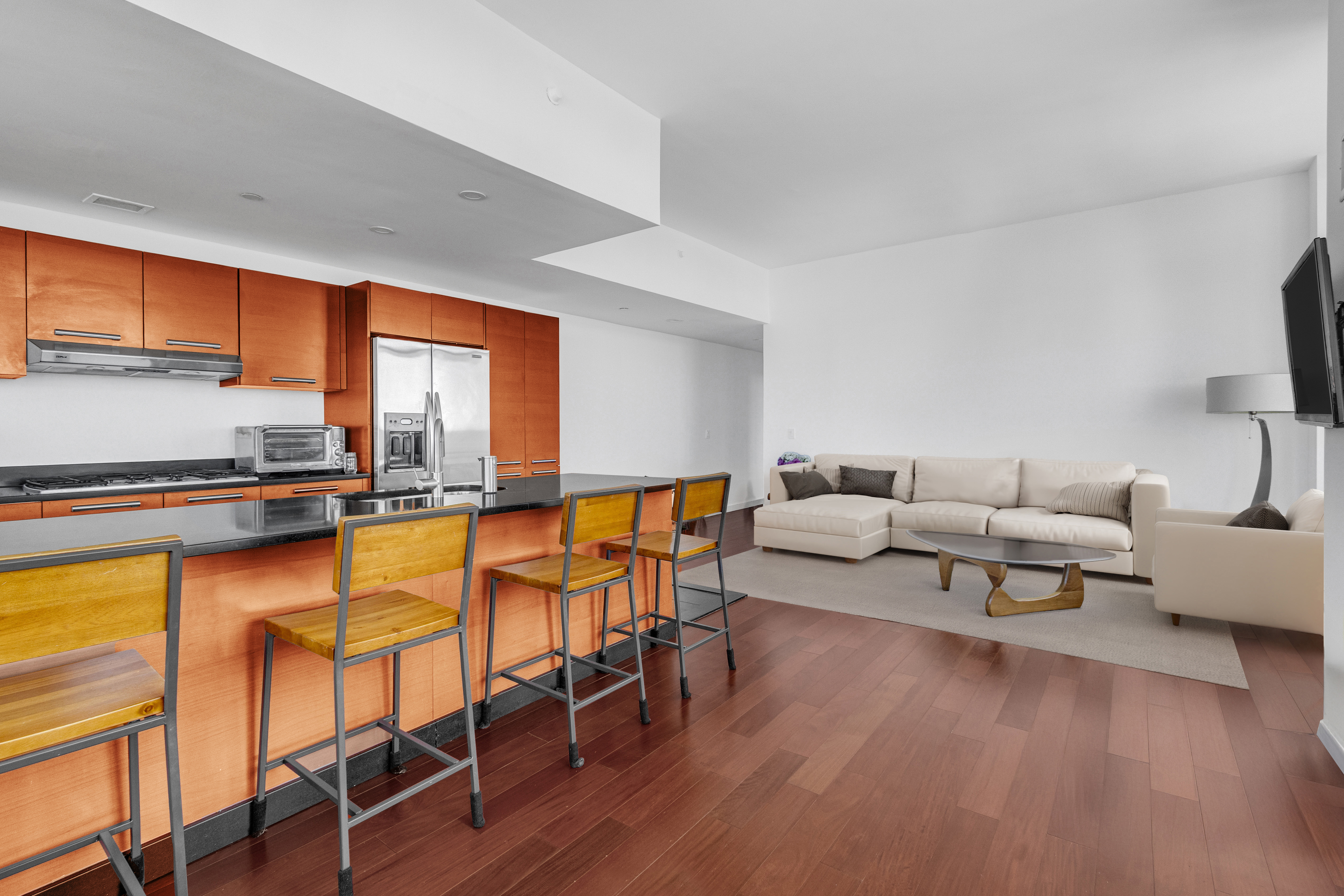 1485 5th Avenue, Unit 24F Manhattan, NY 10035 - Photo 3 of 16 a living room with furniture wooden floor and a flat screen tv