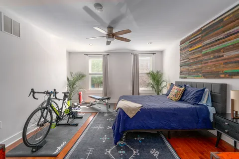a bed room with a bed mirror and a window