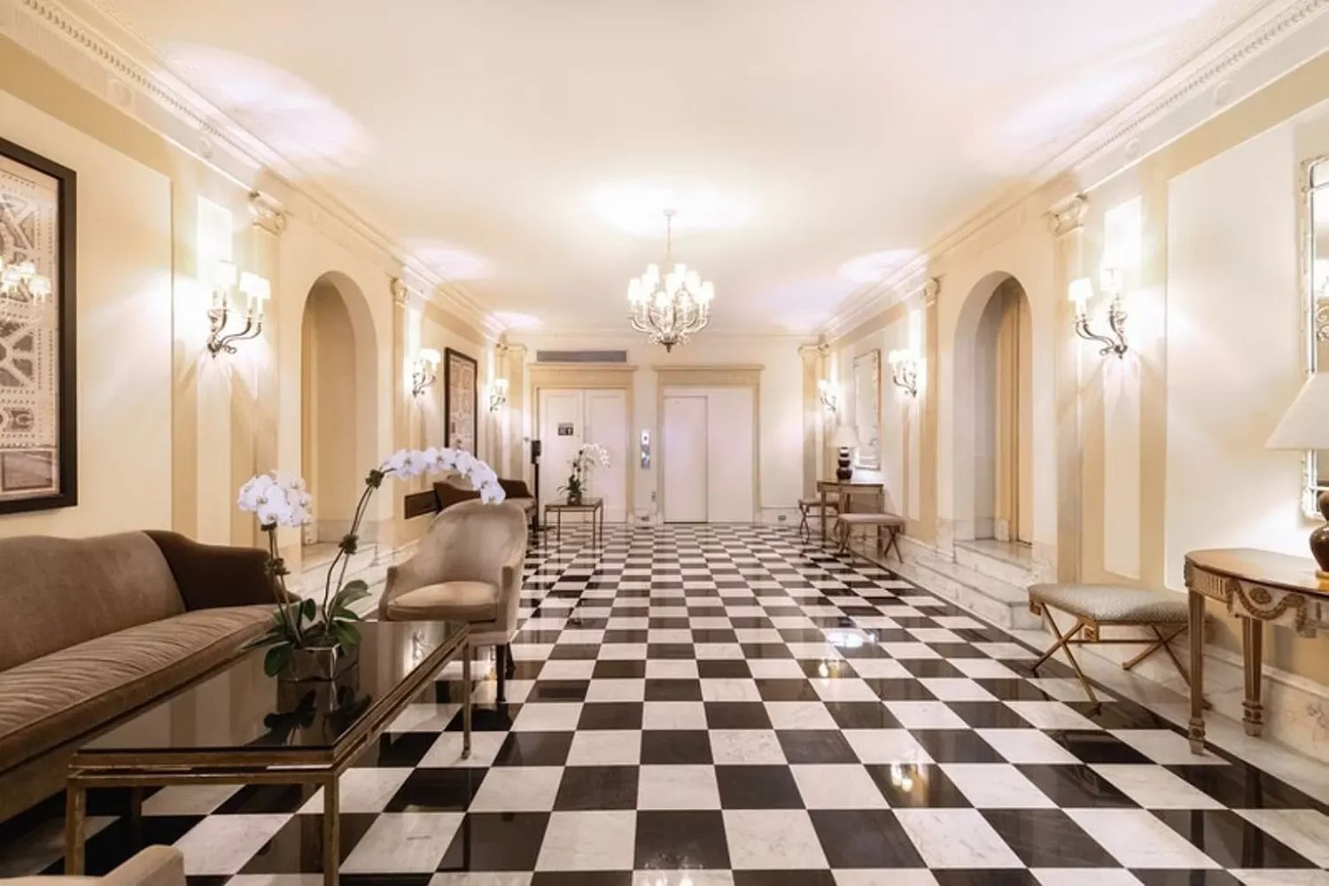 876 Park Avenue, Unit 7N Manhattan, NY 10075 - Photo 20 of 21 a living room with a black white checkered floor with a gaming machine and dining chairs