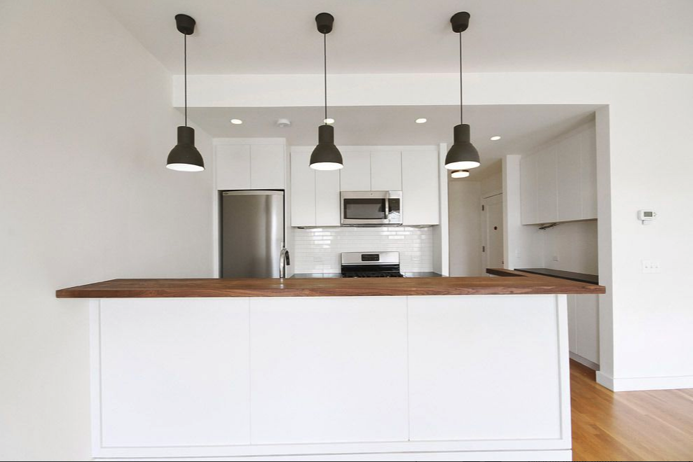 65 1st Place, Unit 3 Brooklyn, NY 11231 - Photo 2 of 7 a open kitchen with stainless steel appliances granite countertop a sink a refrigerator and a wooden floor