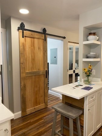 10 Beal's Cove Road, Unit E Hingham, MA 02043 - Photo 2 of 12 a kitchen with a table and chairs