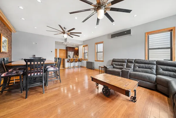 a living room with furniture and wooden floor