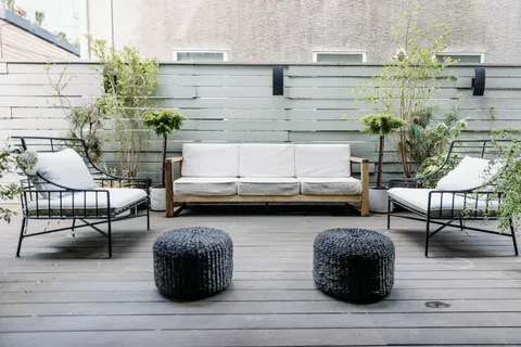 a view of a patio with couches chairs and potted plants