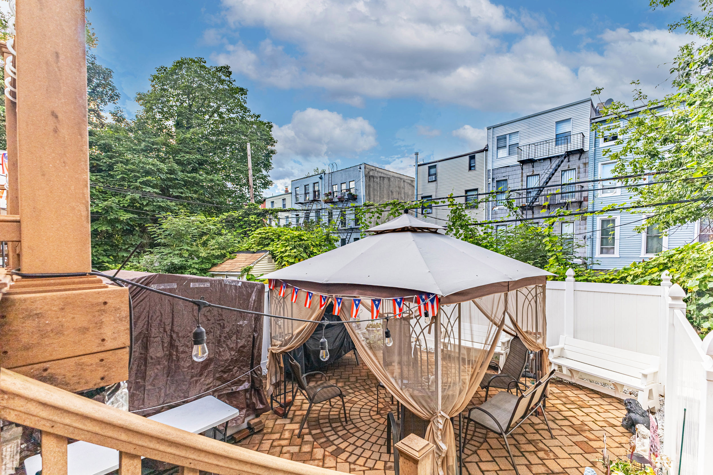 669 Dekalb Avenue Brooklyn, NY 11216 - Photo 14 of 21 a view of a patio with table and chairs with wooden floor and fence