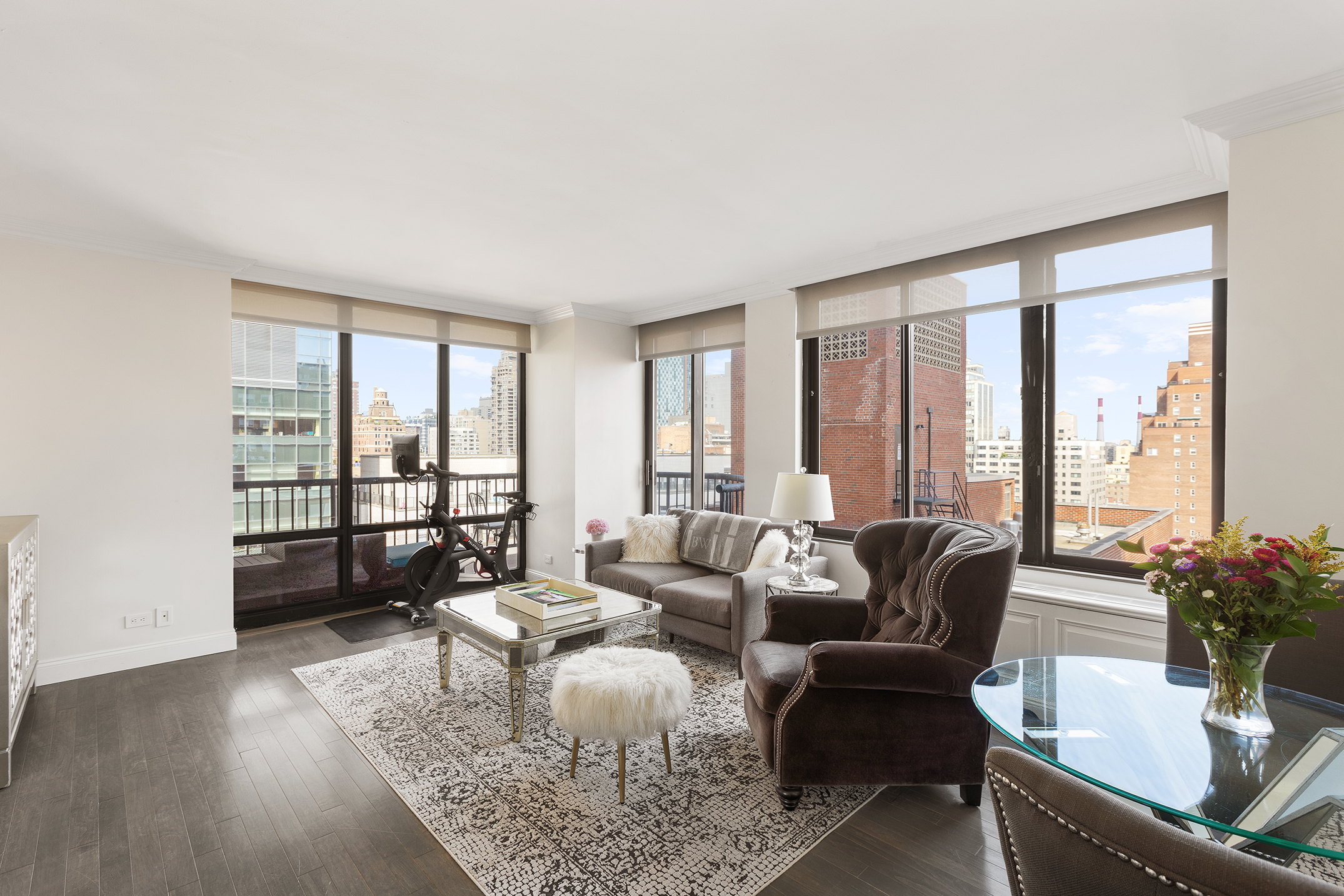 a living room with furniture and floor to ceiling windows