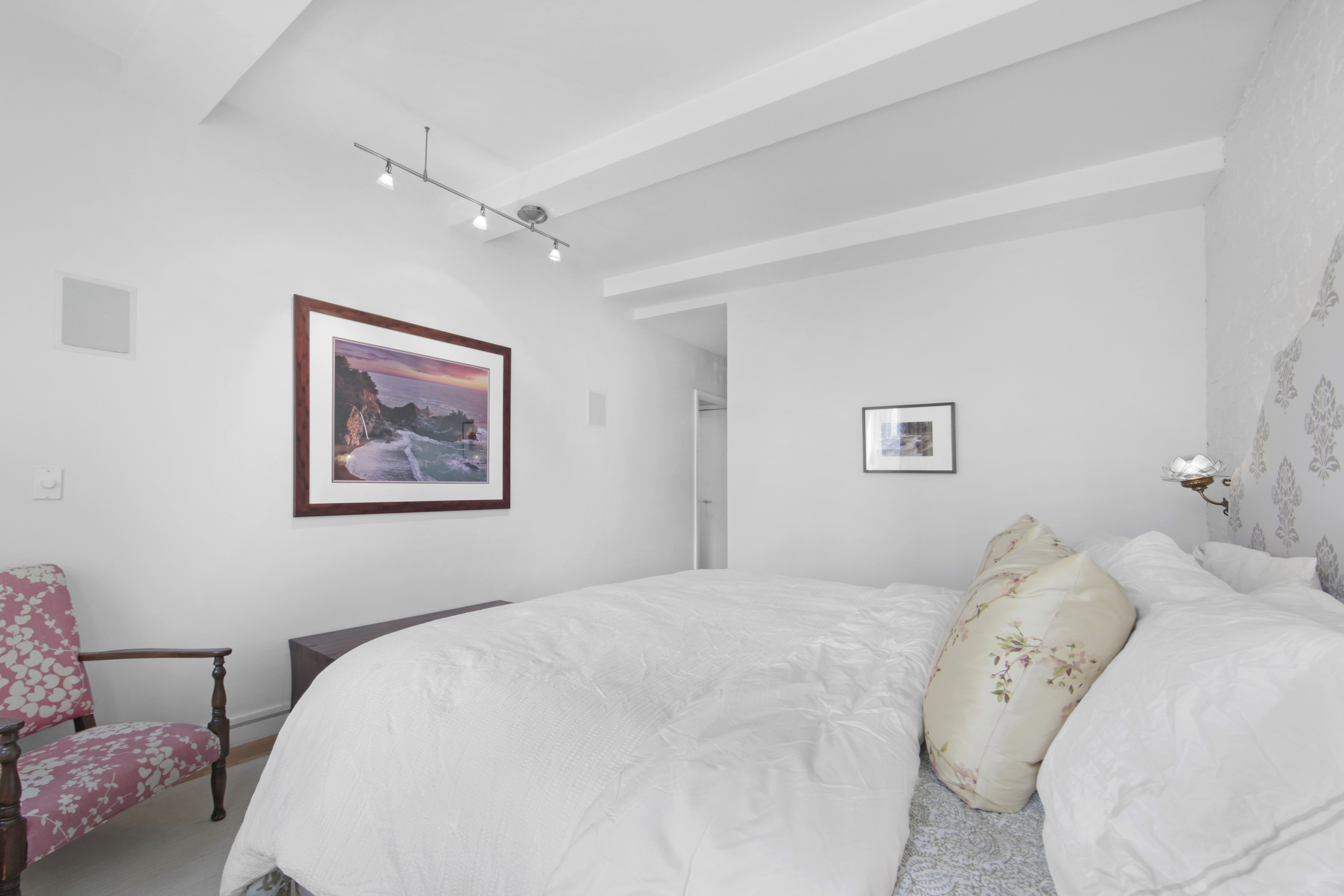 18 East 12th Street, Unit 7BC Manhattan, NY 10003 - Photo 18 of 26 a bedroom with a bed and a painting on the wall