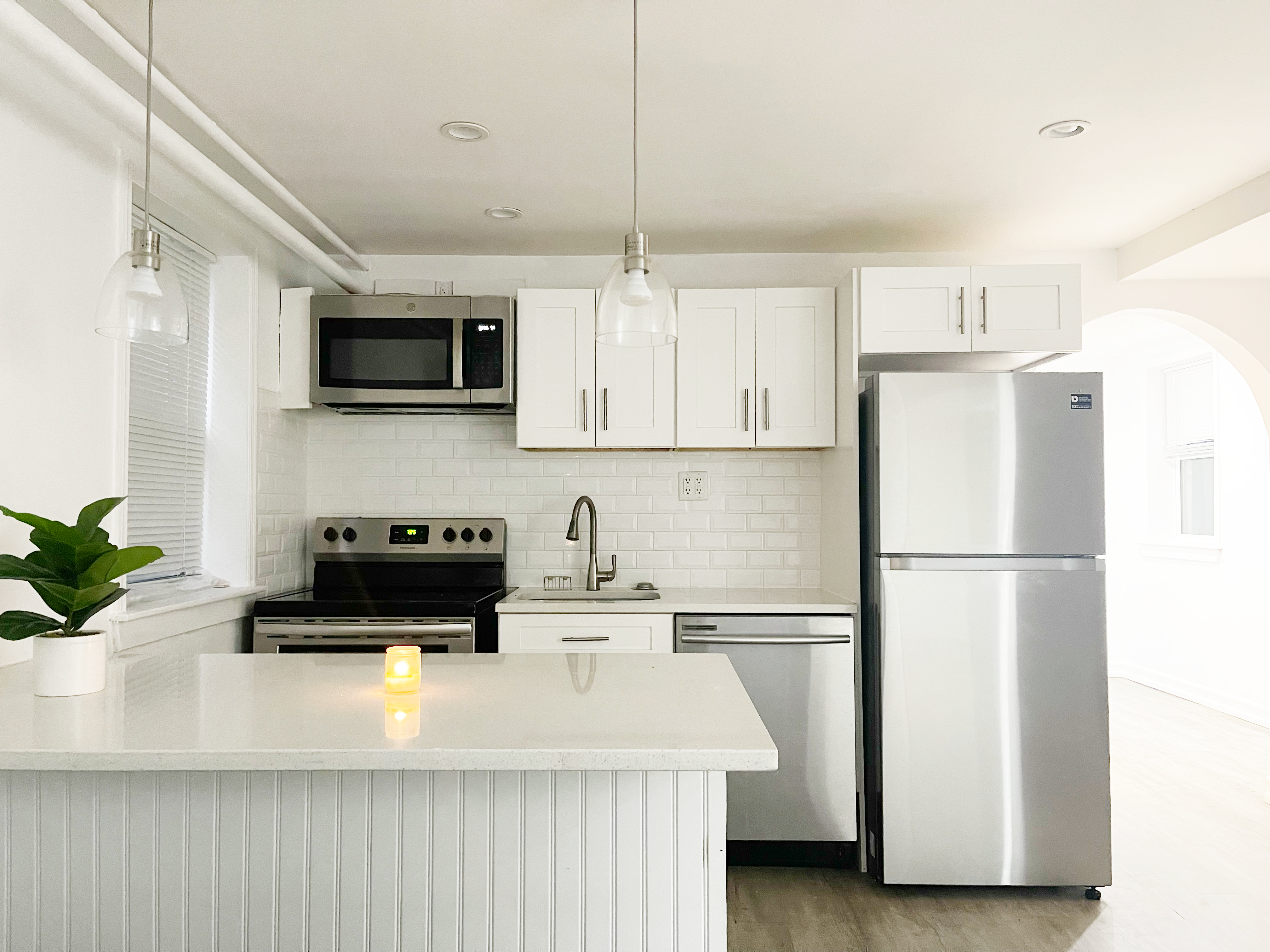 2743 Brighton 7th Street, Unit 1 Brooklyn, NY 11235 - Photo 1 of 9 a kitchen with a refrigerator a microwave and cabinets