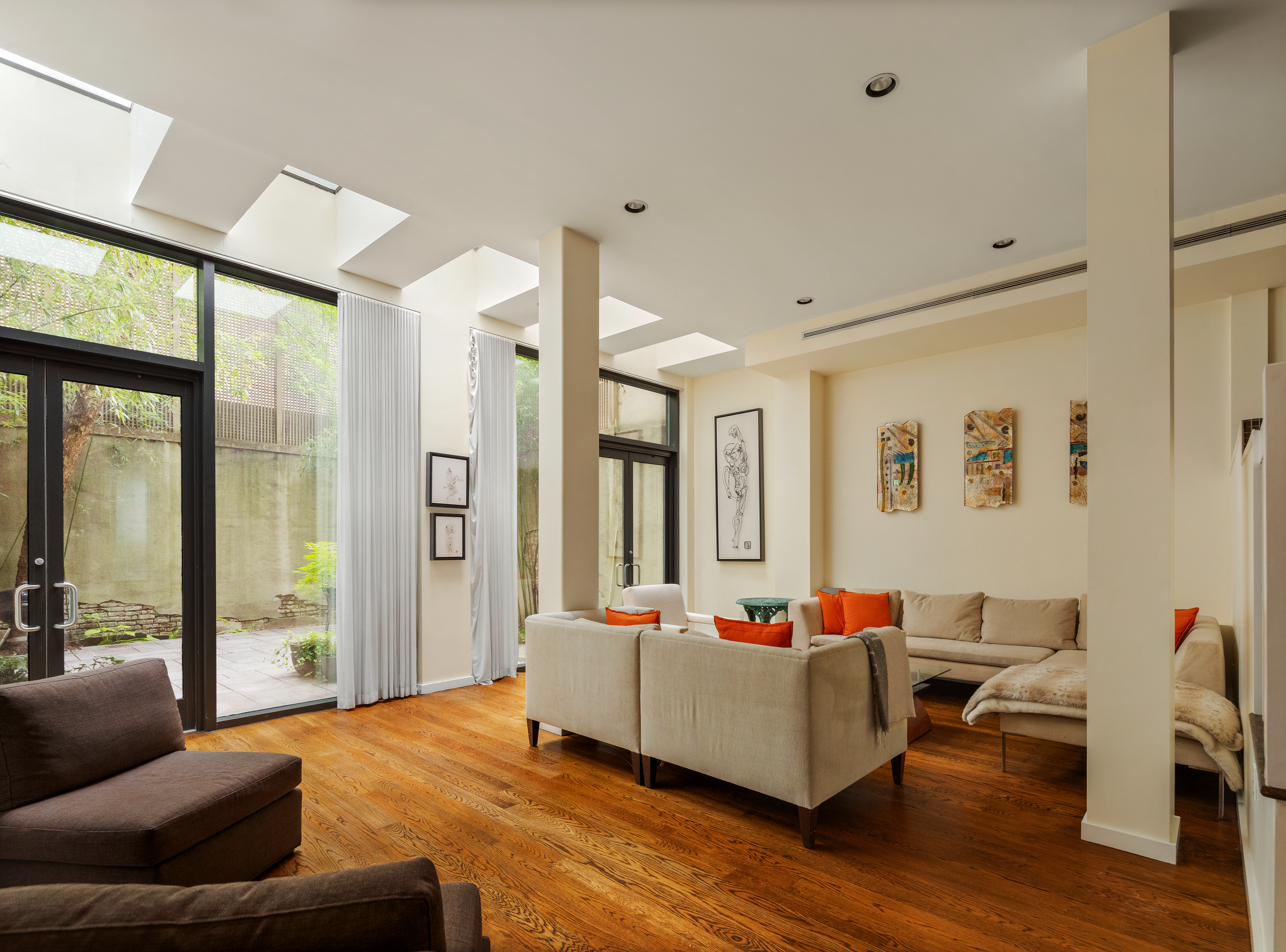 181 Sullivan Street, Unit GARDEN Manhattan, NY 10012 - Photo 1 of 10 a living room with furniture and a large window
