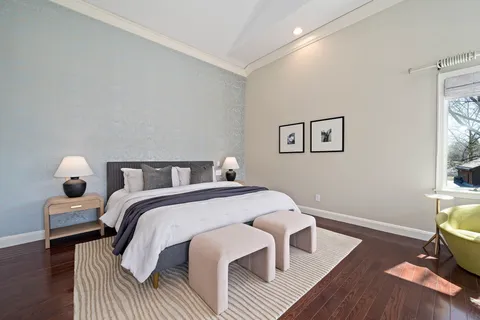 a bed room with a bed and a chair