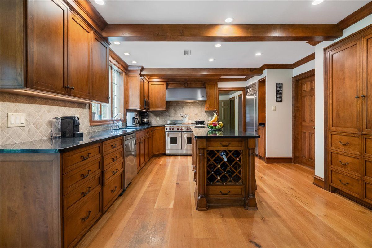 a living room with furniture a fireplace and a large window