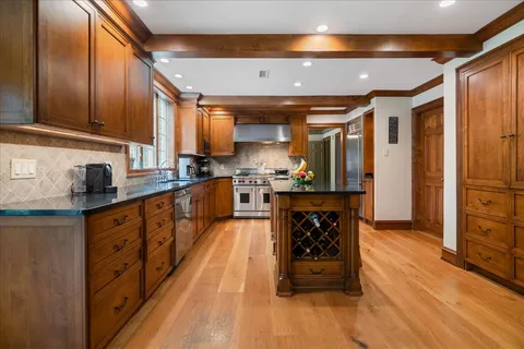 a living room with furniture a fireplace and a large window