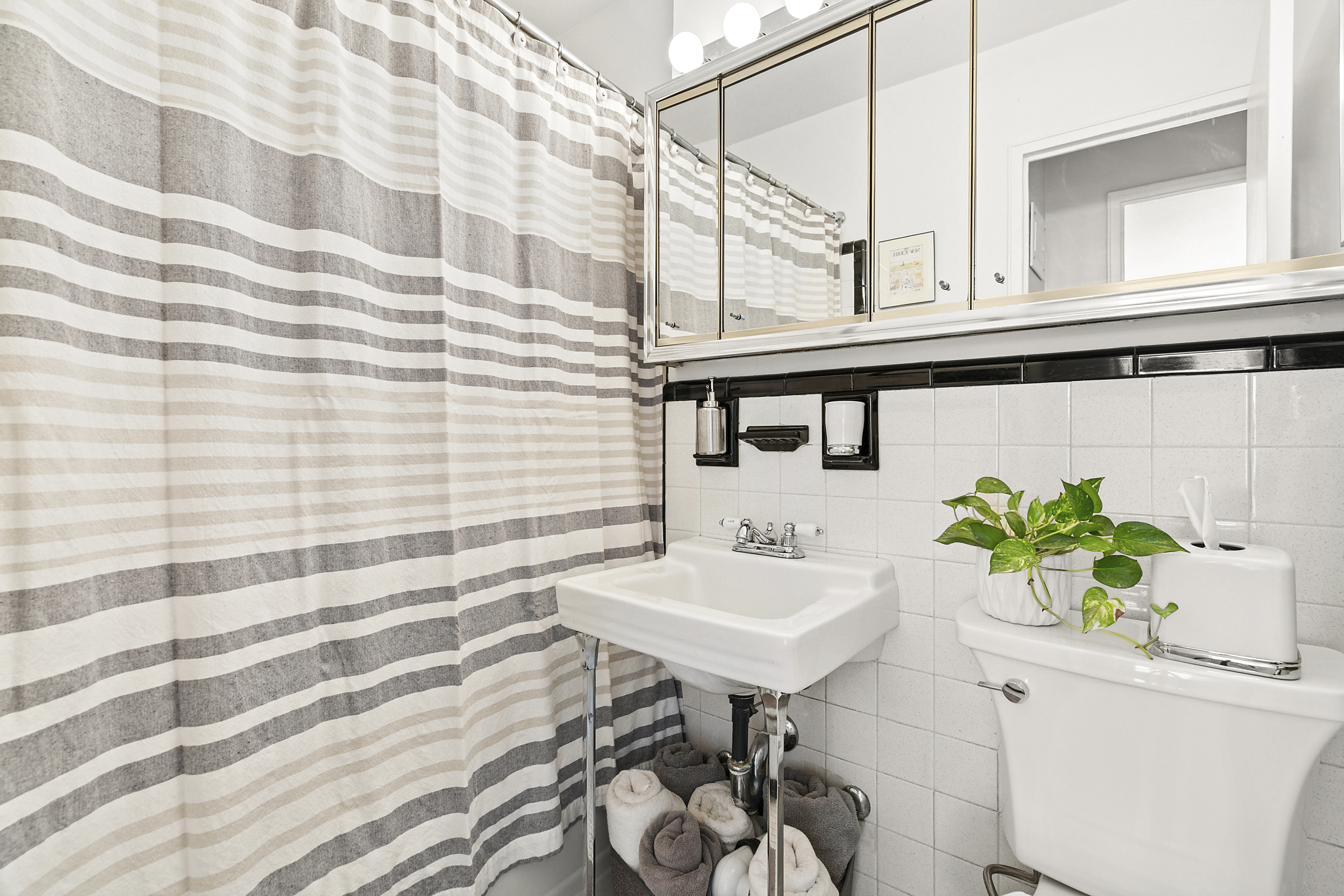 435 East 65th Street, Unit 3G Manhattan, NY 10065 - Photo 5 of 6 a bathroom with a sink and a mirror