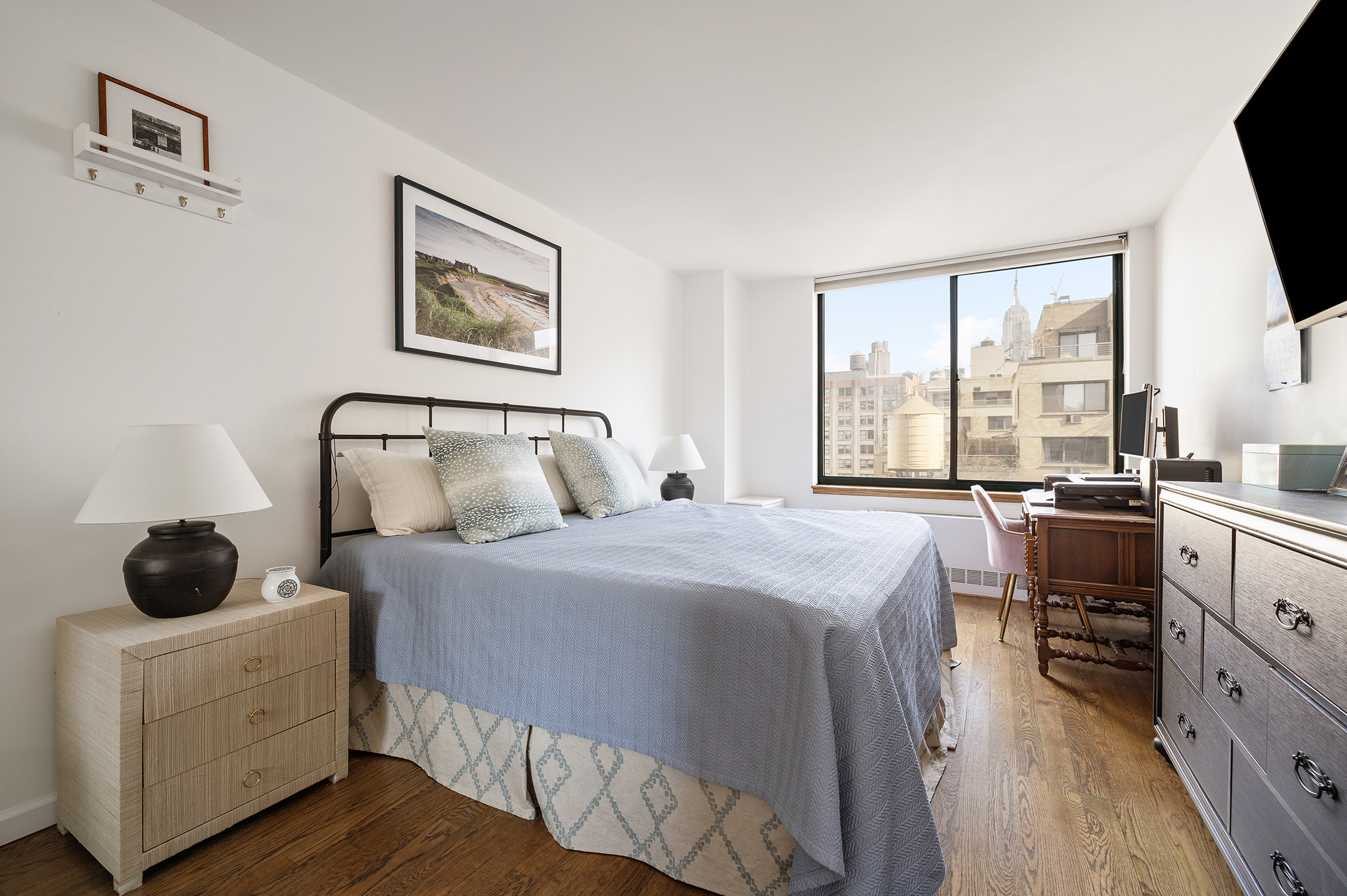 22 West 15th Street, Unit 10G Manhattan, NY 10011 - Photo 4 of 11 a bedroom with a bed and a flat tv screen on the dresser