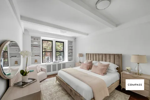 a bedroom with bed couch and window