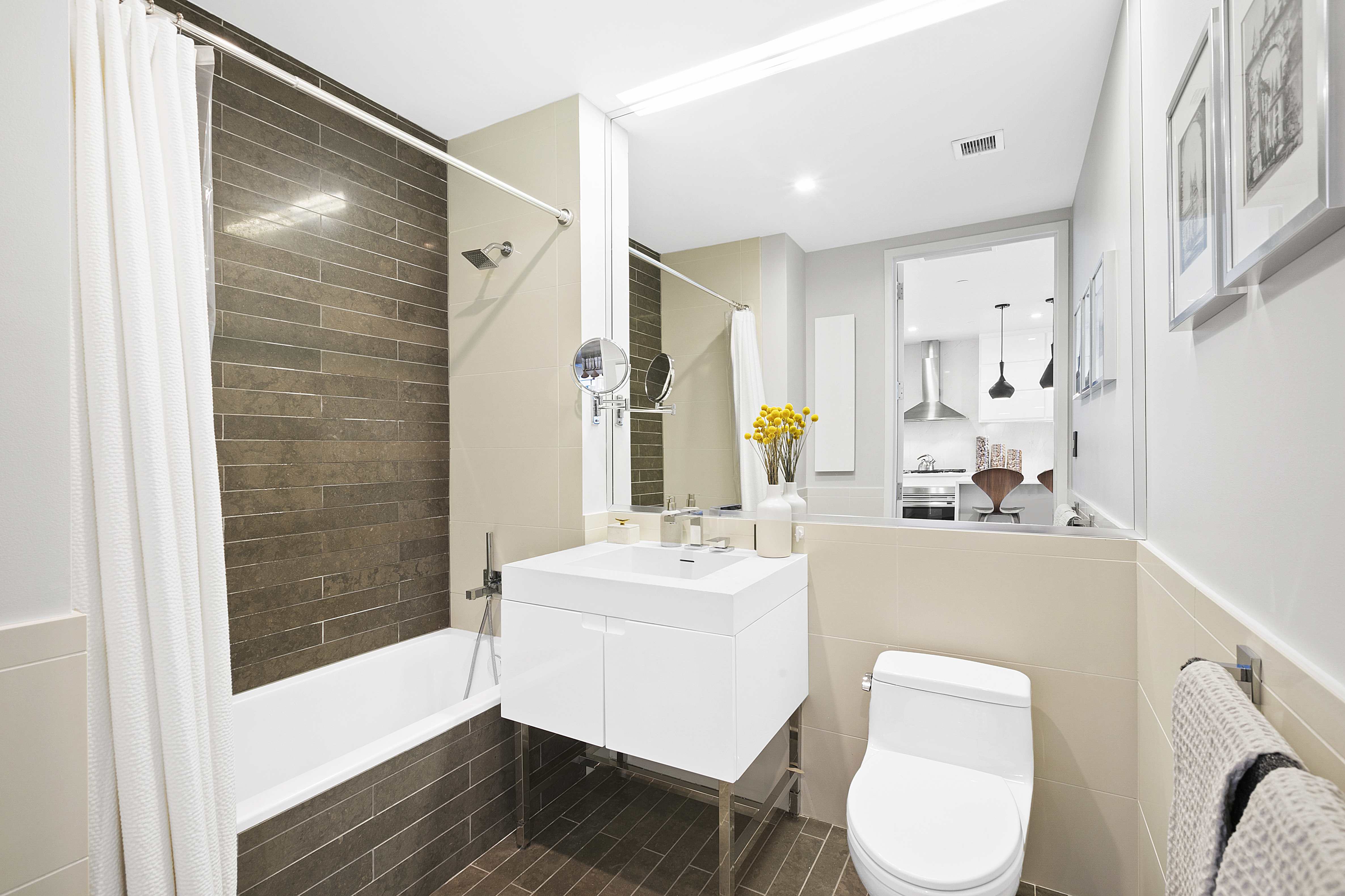 388 Bridge Street, Unit PH45AB Brooklyn, NY 11201 - Photo 19 of 36 a bathroom with a sink toilet a mirror and shower