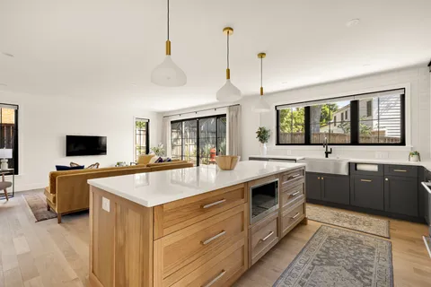 a large kitchen with a stove and a sink