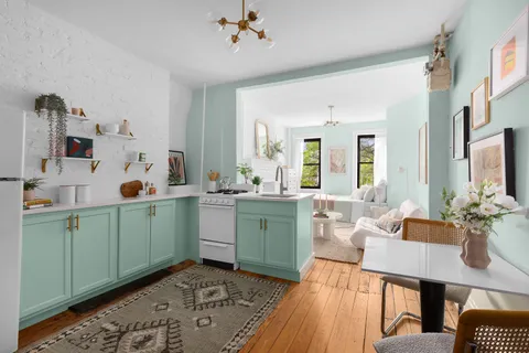 a living room with furniture a flat screen tv and a sink