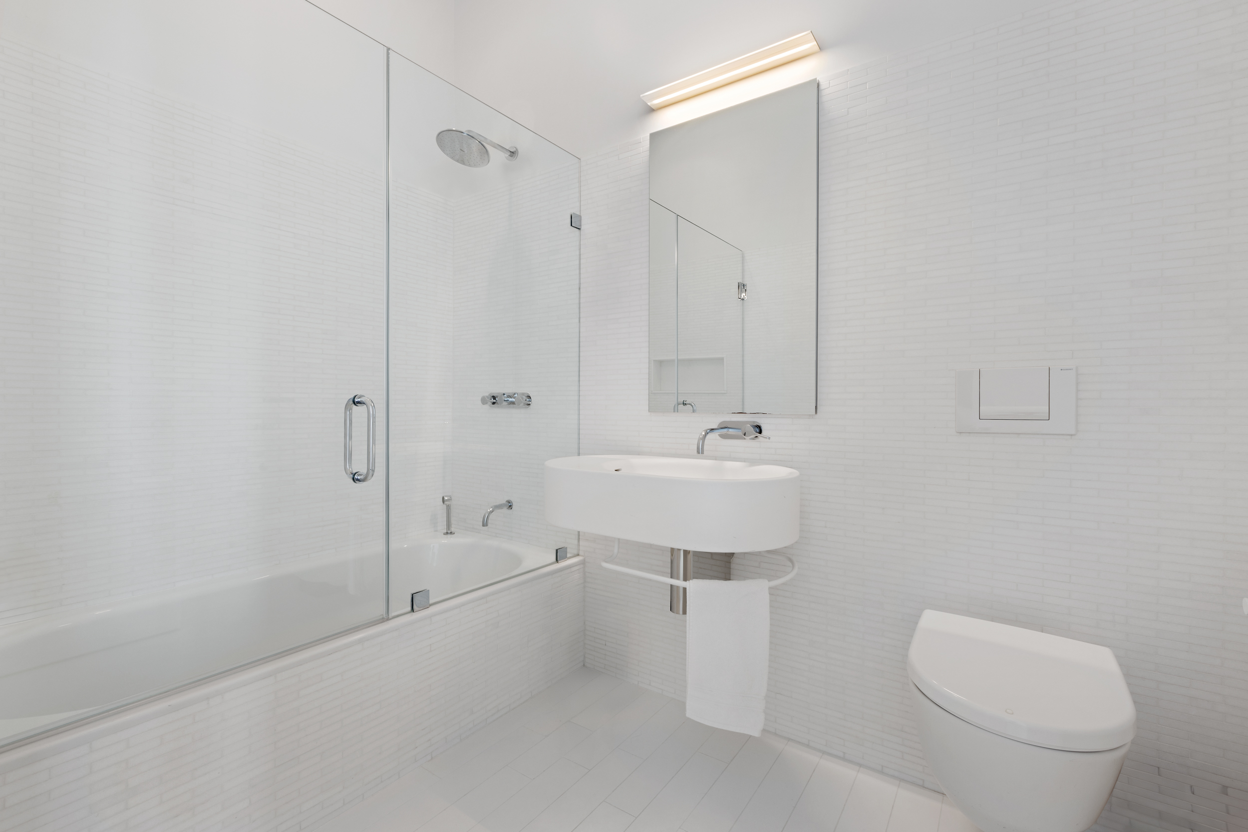 56 Leonard Street, Unit PH52A Manhattan, NY 10013 - Photo 17 of 24 a bathroom with a sink a toilet and shower