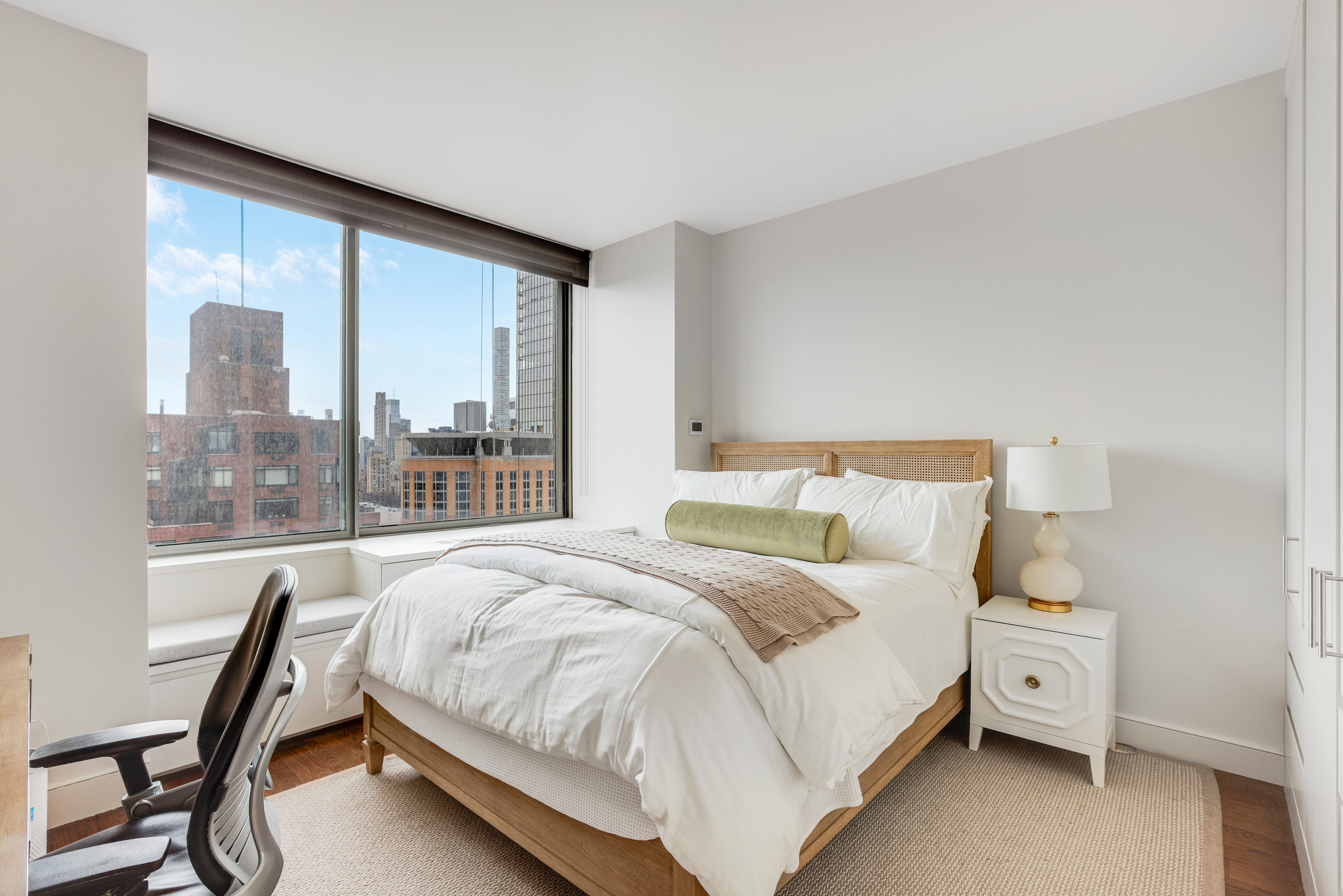 111 West 67th Street, Unit 34F Manhattan, NY 10023 - Photo 8 of 11 a bedroom with a large bed and a window