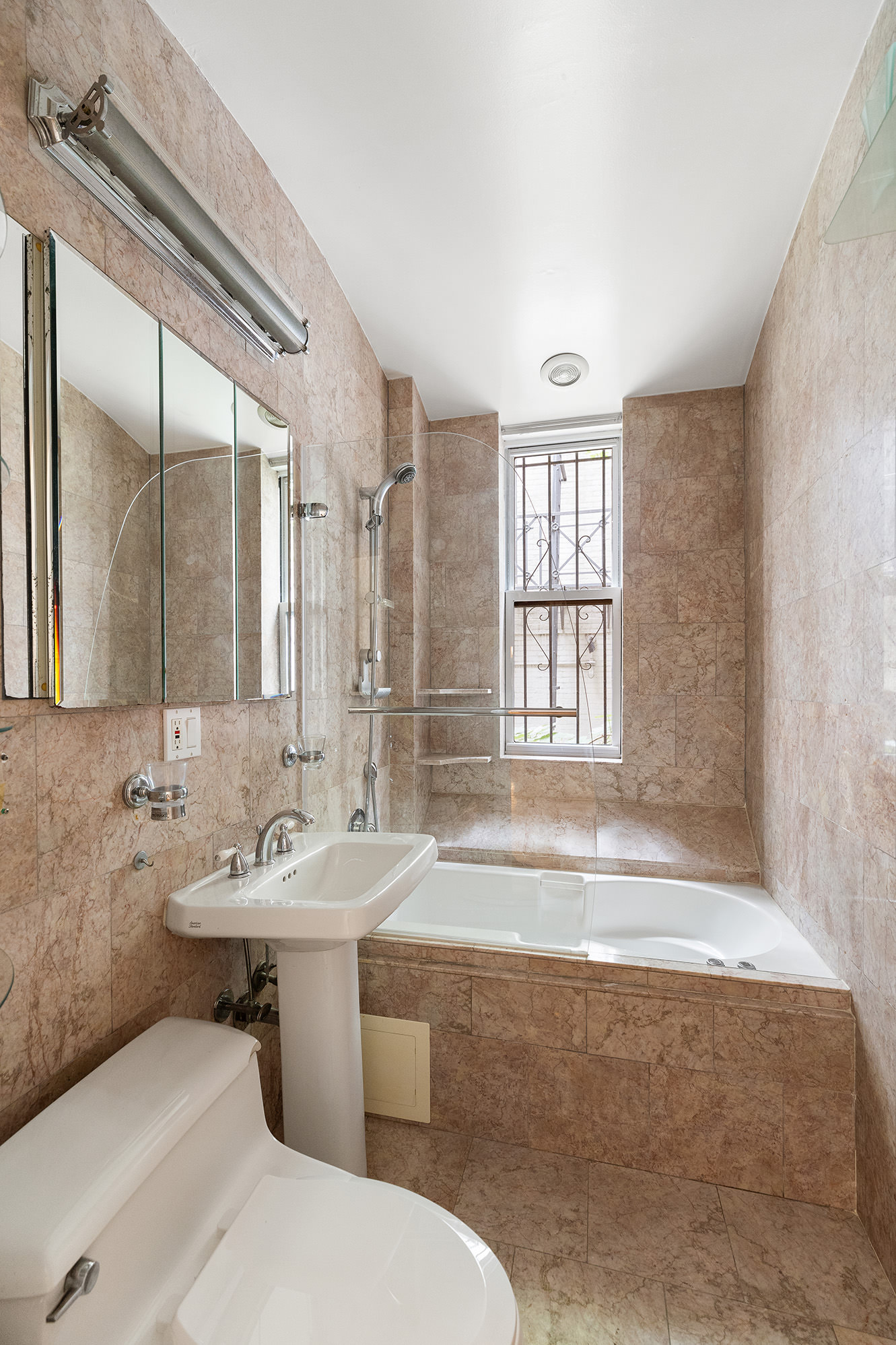 23 East 81st Street, Unit 1 Manhattan, NY 10028 - Photo 12 of 23 a bathroom with a sink and a bathtub