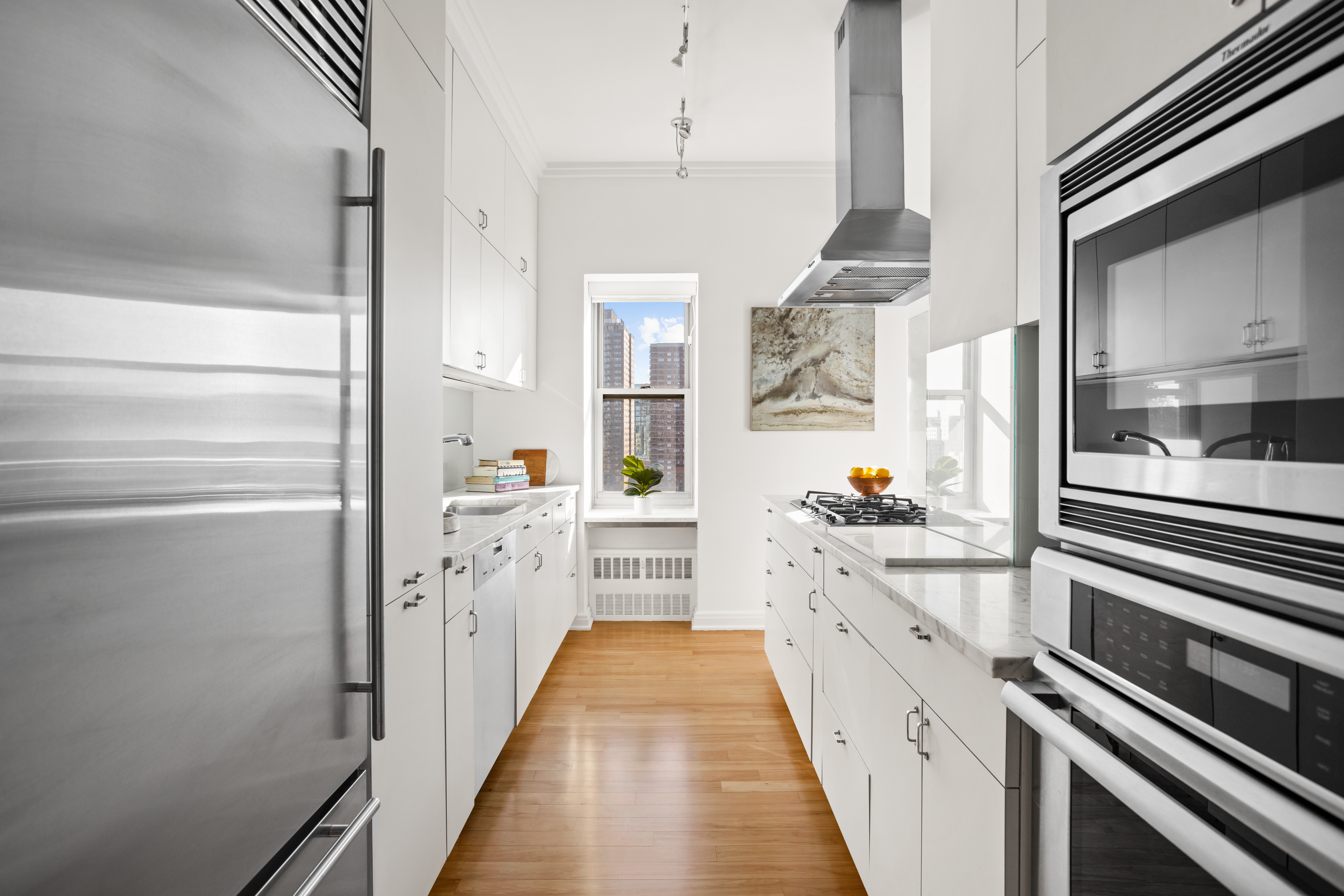 2 5th Avenue, Unit PHDF Manhattan, NY 10011 - Photo 6 of 24 a kitchen with stainless steel appliances a refrigerator and a stove